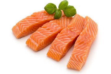 Fresh salmon fillet with basil on the white background.