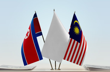 Flags of North Korea and Malaysia with a white flag in the middle