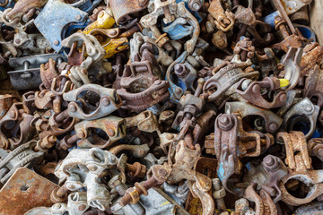 GULF OF THAILAND, OCTOBER 25,2017 : Photo of TCB Scaffold Pipe Clamp, Fixed Clamp, Swivel Camp, Double Camp, Base Plate, Beam Clamp, Putlog Camp and Sleeve Camp are pile together on the floor.