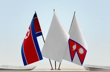 Flags of North Korea and Nepal with a white flag in the middle