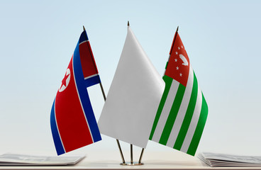 Flags of North Korea and Abkhazia with a white flag in the middle