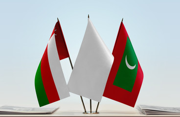 Flags of Oman and Maldives with a white flag in the middle