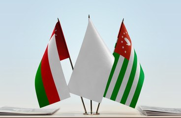 Flags of Oman and Abkhazia with a white flag in the middle