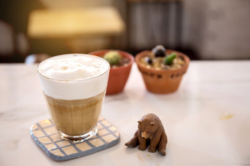 Hot coffee in a white cup on table