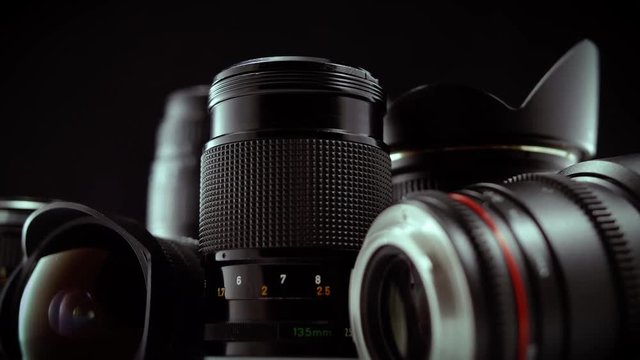 Close Up Camera Lenses Spinning on Black Background