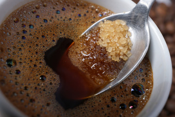 Close up of adding brown sugar in traditional Turkish coffee