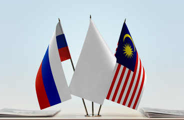 Flags of Russian Federation and Malaysia with a white flag in the middle