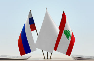 Flags of Russian Federation and Lebanon with a white flag in the middle