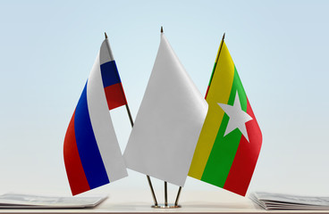 Flags of Russian Federation and Myanmar with a white flag in the middle