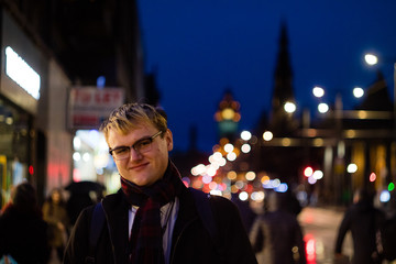A handsome young man in the city at night