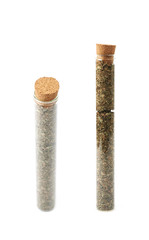 Herbal spices in a glass vial isolated