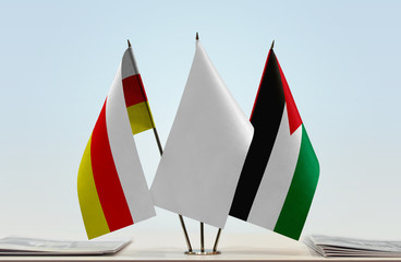 Flags of South Ossetia and Palestine with a white flag in the middle