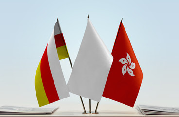 Flags of South Ossetia and Hong Kong with a white flag in the middle