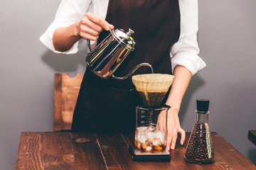 Women Barista making drip coffee in the cafe