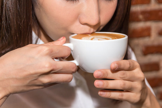 Woman drinking coffee at coffee shop