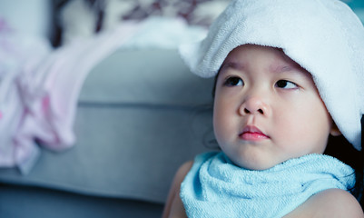 Mother rub the body with wet cloth to reduce the fever for daughter.tepid sponge for her little girl at home.