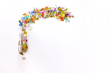 Colorful celebration with champagne glasses and colorful paper on white background.flat lay, top view
