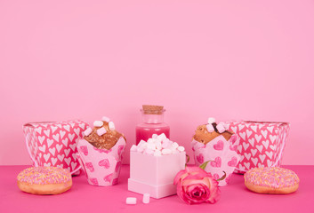 Muffins in colorful paper baking cup with red hearts.