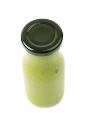 Green sauce in a bottle isolated