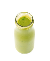 Green sauce in a bottle isolated