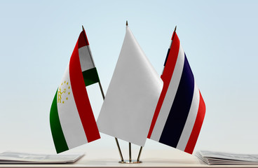 Flags of Tajikistan and Thailand with a white flag in the middle