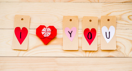 valentine's day holiday. paper labels with hearts made in i love you message with redorigami paper heart