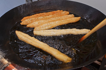 Deep fried  Chinese fried bread stick in hot oil