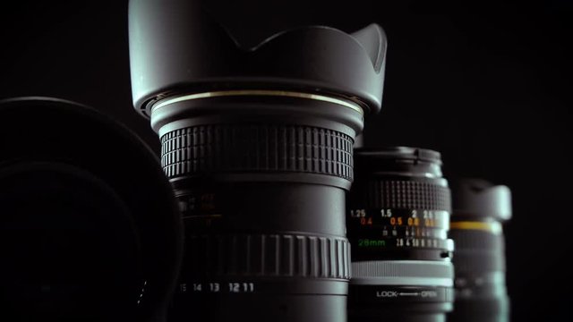 Macro Cinematic Reveal of Camera Lenses on Black Background