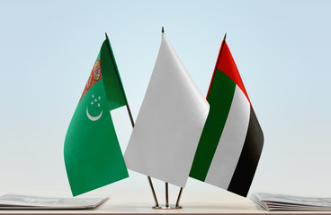 Flags of Turkmenistan and UAE with a white flag in the middle