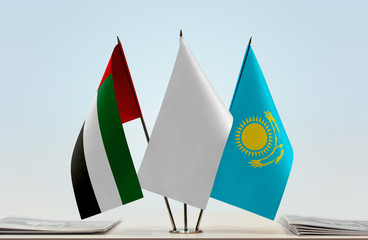 Flags of UAE and Kazakhstan with a white flag in the middle