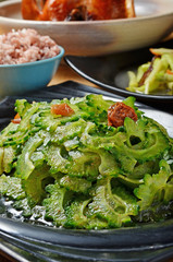 Bitter melon with sauce on black plate