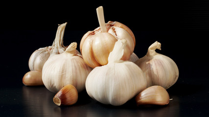 Group of garlic in the black bacground.
