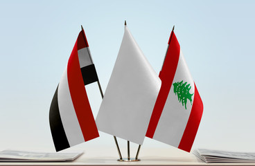 Flags of Yemen and Lebanon with a white flag in the middle