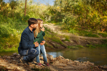 Naklejka na ściany i meble Family. Father and daughter by river