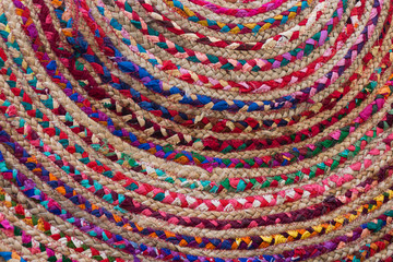 Rag Rug Close Up with colorful braided fabric sewn in a circle. 
