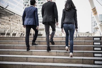 Group of Business people Walking up the stairs the way to go work.