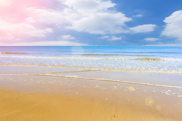 The sea and the beach under the blue sky and white clouds