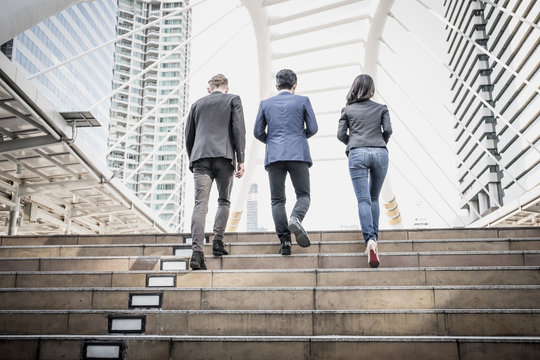 Group of Business people Walking up the stairs the way to go work.