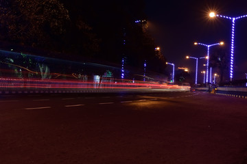 Naklejka na ściany i meble Car Light trails on a city street in a night