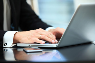 Fototapeta premium Closeup of hand business man using laptop for work at office