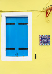 yellow house with blue shutter