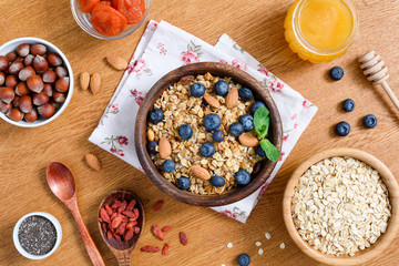 Healthy lifestyle breakfast with granola, honey, oats, superfoods and chia seeds. Dieting, healthy eating, weight loss concept. Table top view