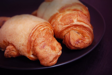 Two close Up Croissant with Chocolate Cream on Black Plate. copy Paste. Breakfast.