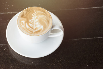 Cup of latte or cappuccino on the table in cafe