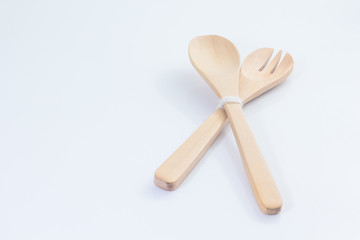 Wooden spoon and fork on white background with copy space