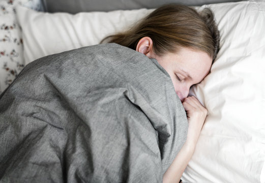 Caucasian woman sleeping in bed