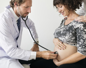Pregnant woman having fetal monitoring by doctor