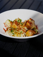 Pasta with trout in a white plate on the table