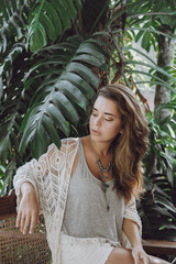Portrait of a woman on a palm leaf background