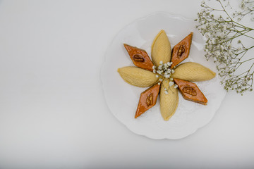 A plate with national pakhlava and shekarbura as Novruz symbol